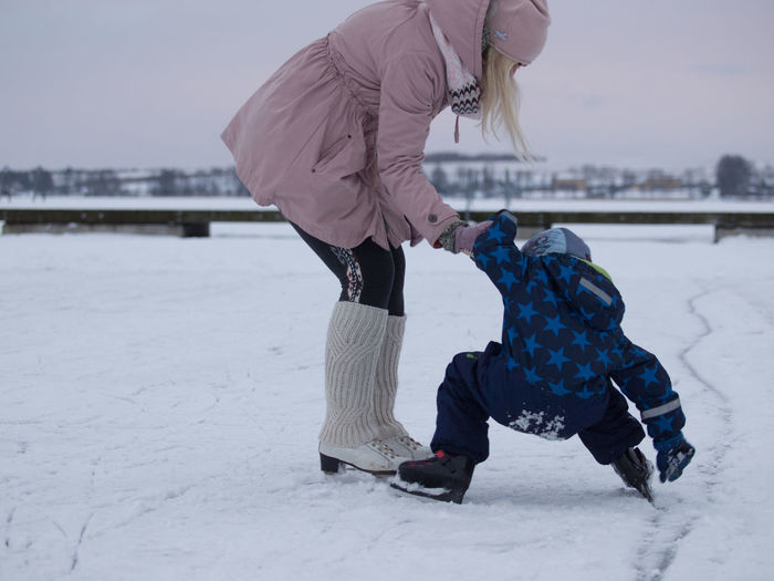 Woman with child on ice rink