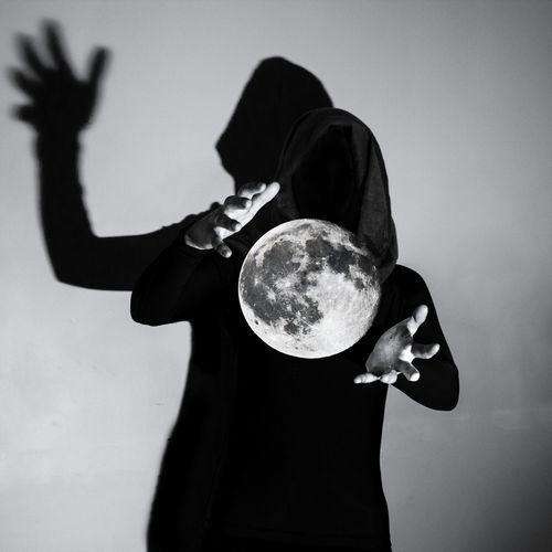 Magician performing trick with moon