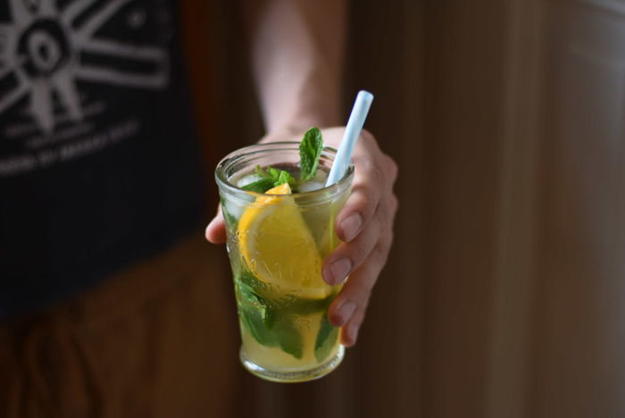 Close-up of person holding lemon beverage