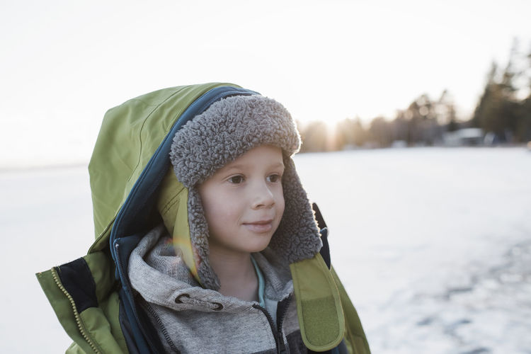 Portrait of boy at the beach at sunset in winter