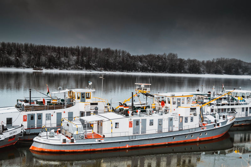 Ships in river against sky