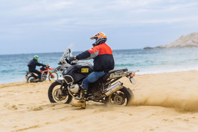 People riding motorcycle on beach