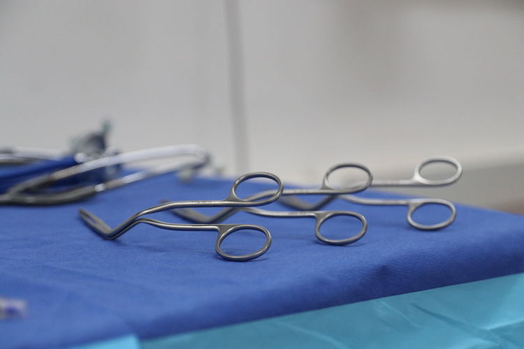 Close-up of surgical scissors on table at hospital