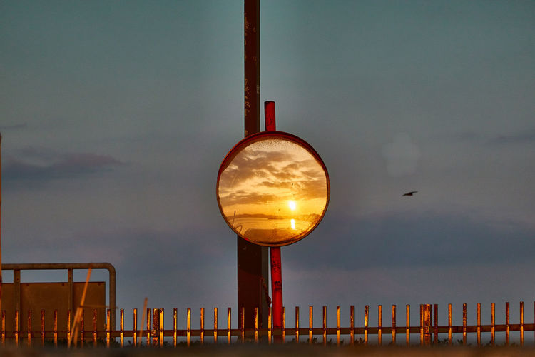 Lamp post against sky during sunrise