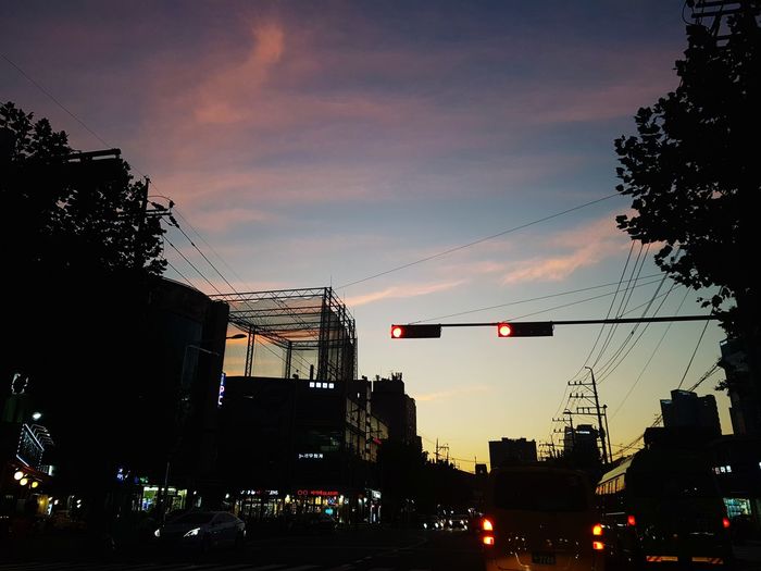 Low angle view of silhouette buildings against sky during sunset