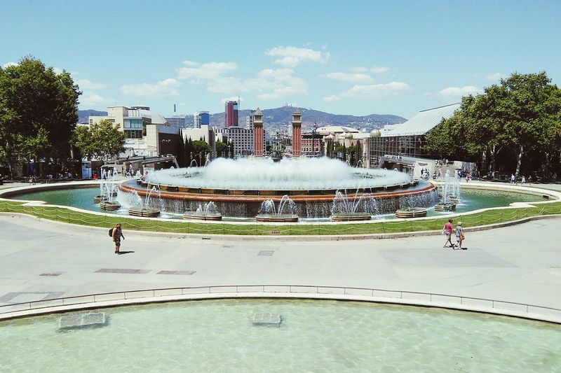 Magic fountain at plaza de espana in city against sky