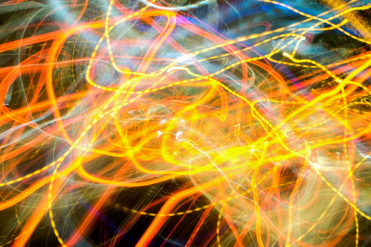 Full frame shot of multi colored light painting against black background
