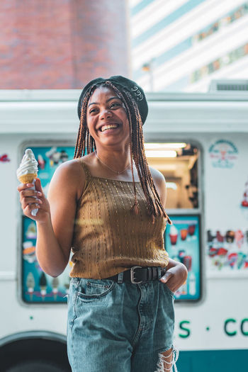 Portrait of a smiling young woman holding ice cream