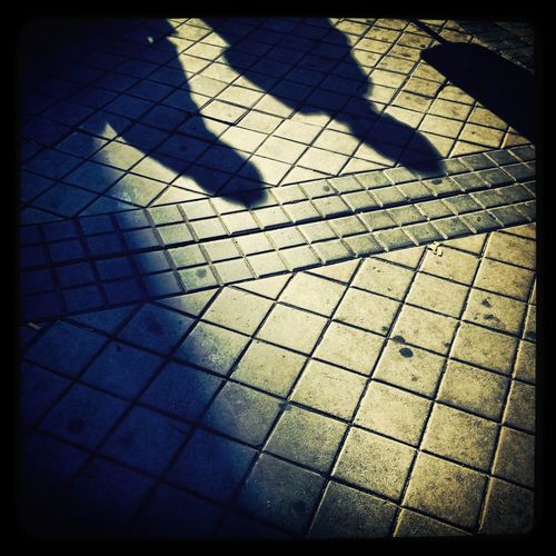 Shadow of people on footpath
