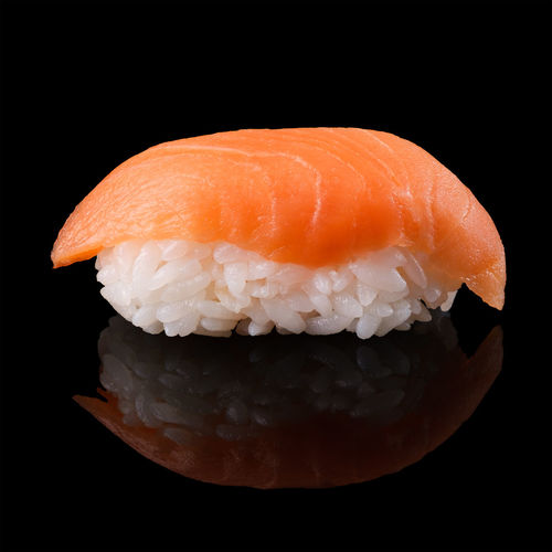 Close-up of sushi served on black background