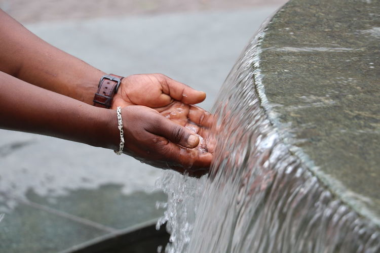 Close-up of hands holding water fountain