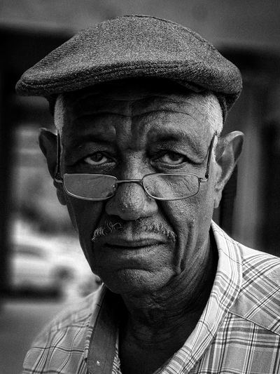 Close-up portrait of old man wearing eyeglasses