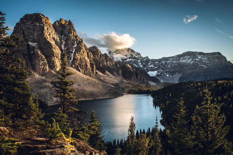 Sunset over sunburst peaks and cerulean lake near mount assiniboine, british columbia, canada