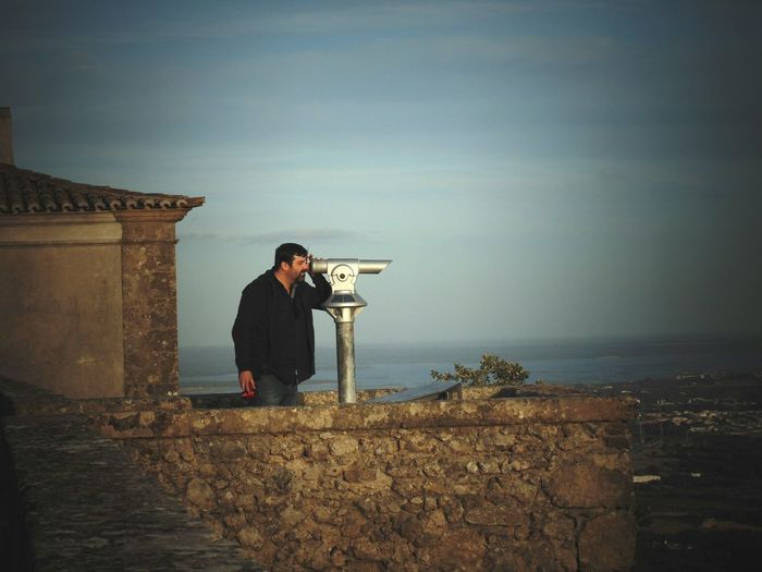 Man looking into binoculars