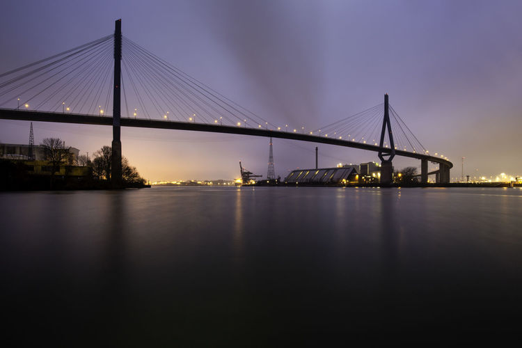 Illuminated suspension bridge over river
