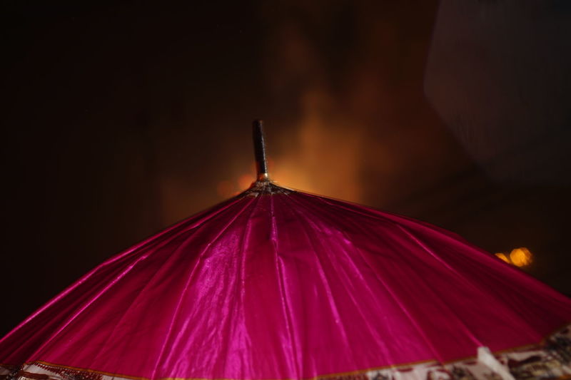 Close-up of illuminated umbrella against sky at night