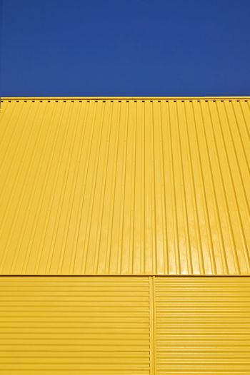 Background pattern yellow galvanized metal profile against the sky