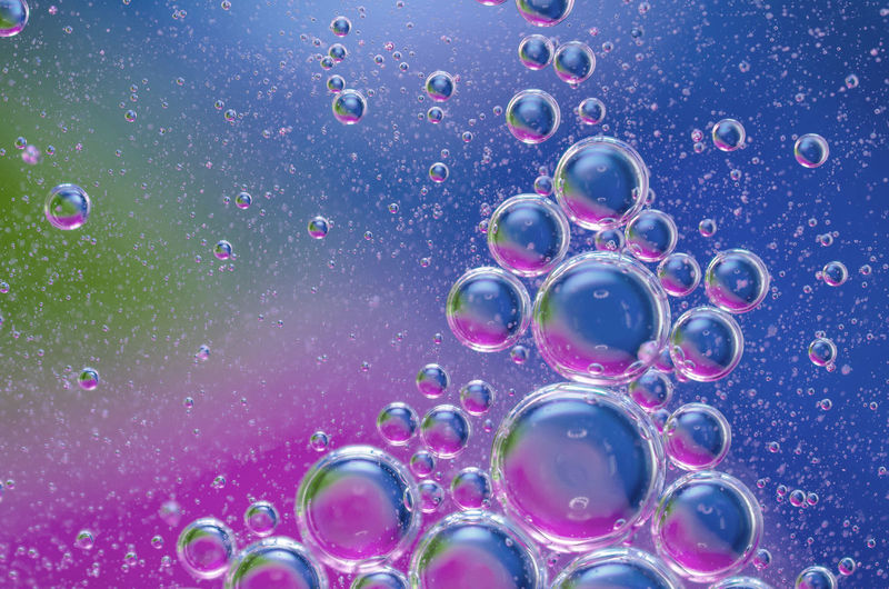 Close-up of water drops on multi colored bubbles
