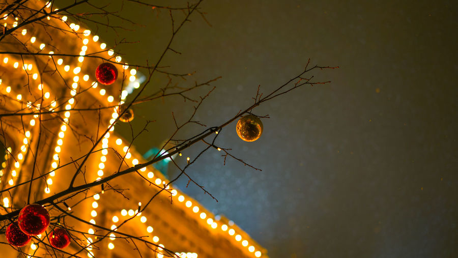 Low angle view of illuminated christmas lights at night