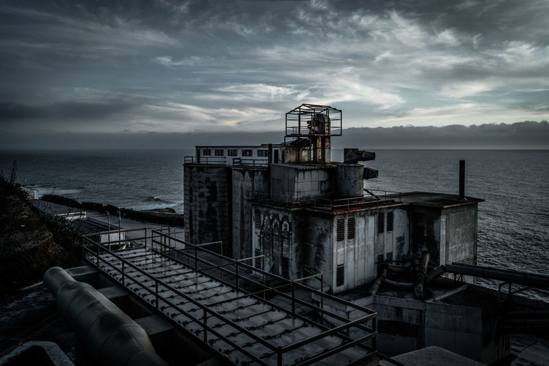 High angle view of abandoned building by sea