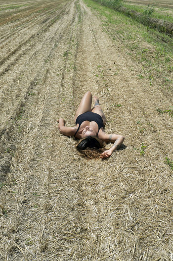 High angle view of woman lying on land