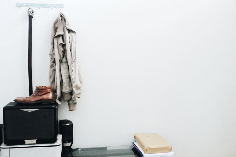Luggage and clothing against wall