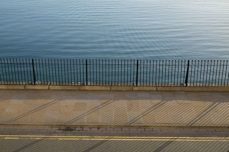 High angle view of railing by sea