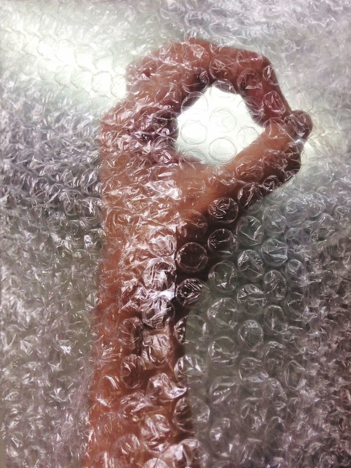 CLOSE-UP OF HUMAN HAND ON GLASS