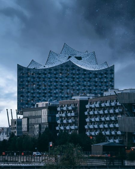 Modern building against cloudy sky