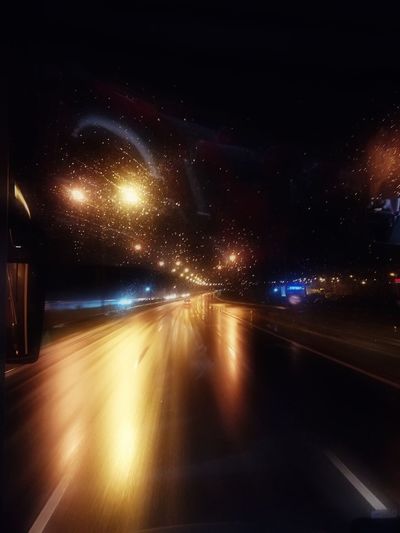 Illuminated road in city at night