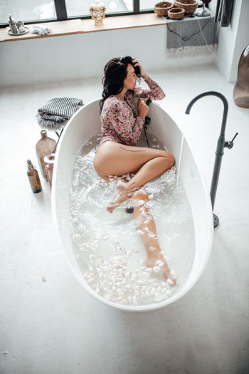 High angle view of beautiful woman relaxing in bathtub