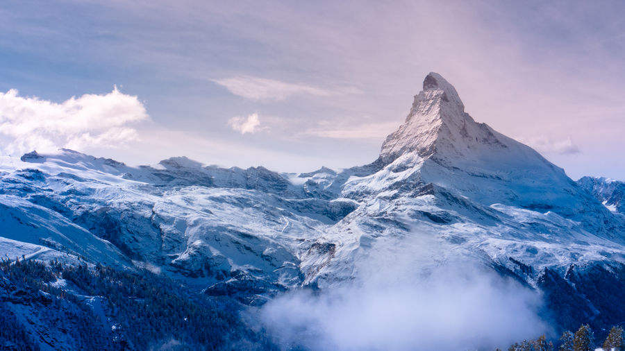 Scenic view of snowcapped mountains against sky