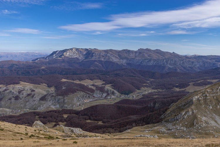 Scenic view of mountains against cloudy sky
