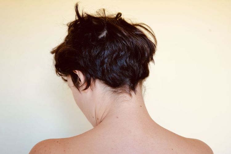 Rear view of woman against white background
