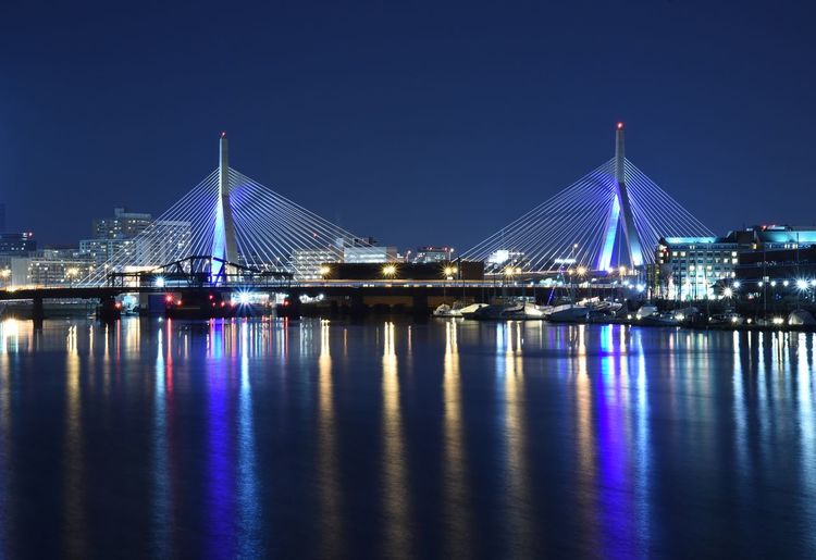 Illuminated leonard p zakim bunker hill bridge over charles river at night