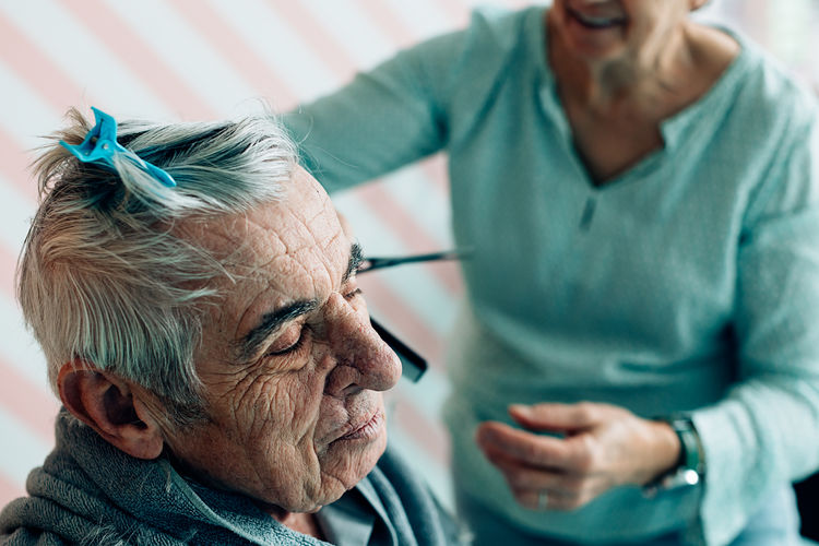 Elderly lifestyle. two old people at home. haircut in a barbershop or hospice.
