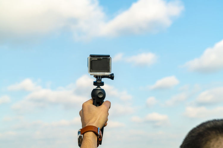 Tourist taking video with action camera in summer