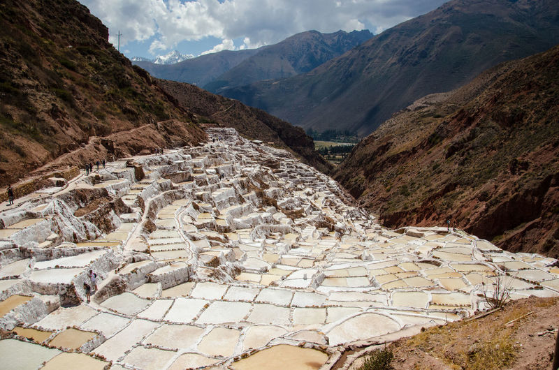 High angle view of salt pans against rocky mountains