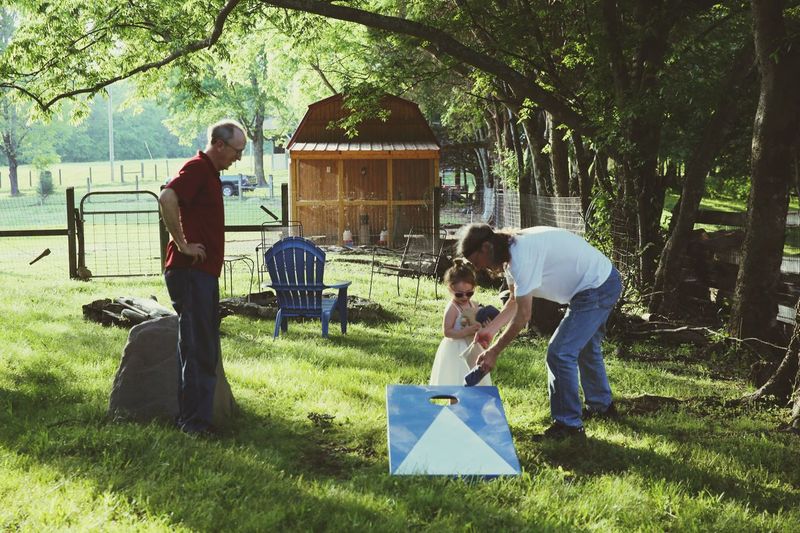 Grandparents with girl at back yard during summer