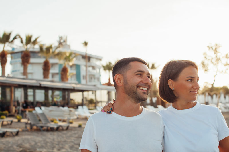 Happy portrait couple in love on the beach. family. diverse couple on summer vacation.
