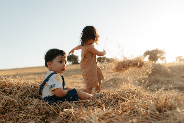 Brother and sister playinh outdoors