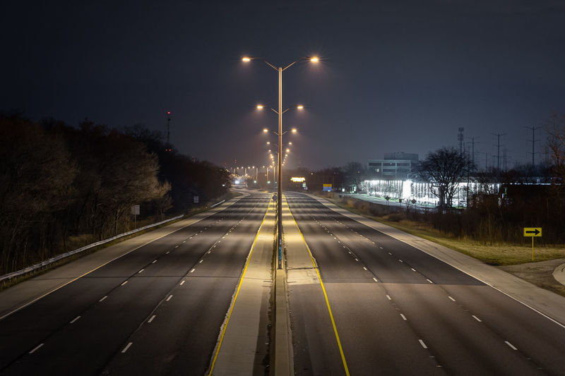 Empty interstate highway through a suburban area
