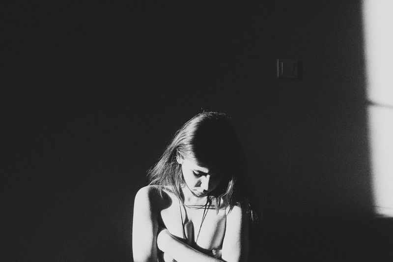 Shirtless young woman at home