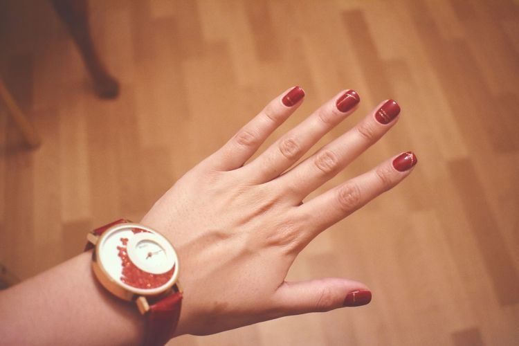 Cropped hand of woman with red nails