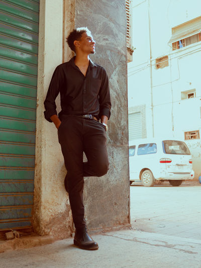 Portrait of young man standing on street