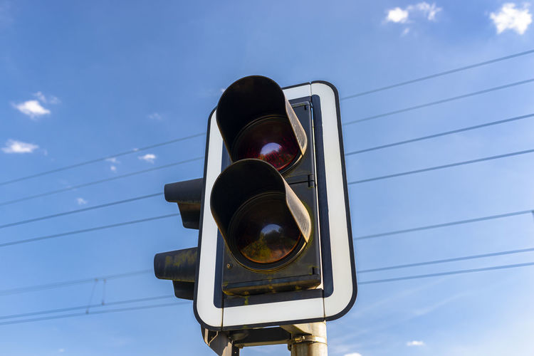 Traffic lights before the railway crossing with a red light to warn of approaching trains.