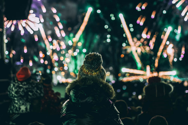 People watching firework display at night