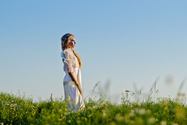 Low angle view of woman against clear sky