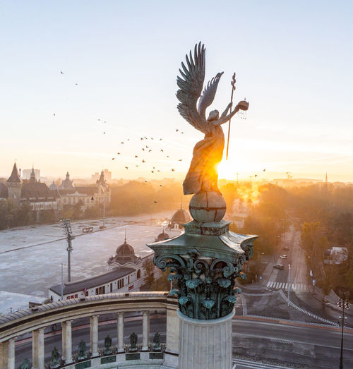 Low angle view of statue against sky during sunset