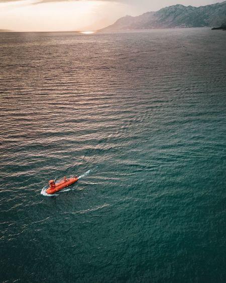 High angle view of submarine in sea during sunset